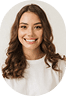 Smiling young woman with long wavy brown hair wearing a white top