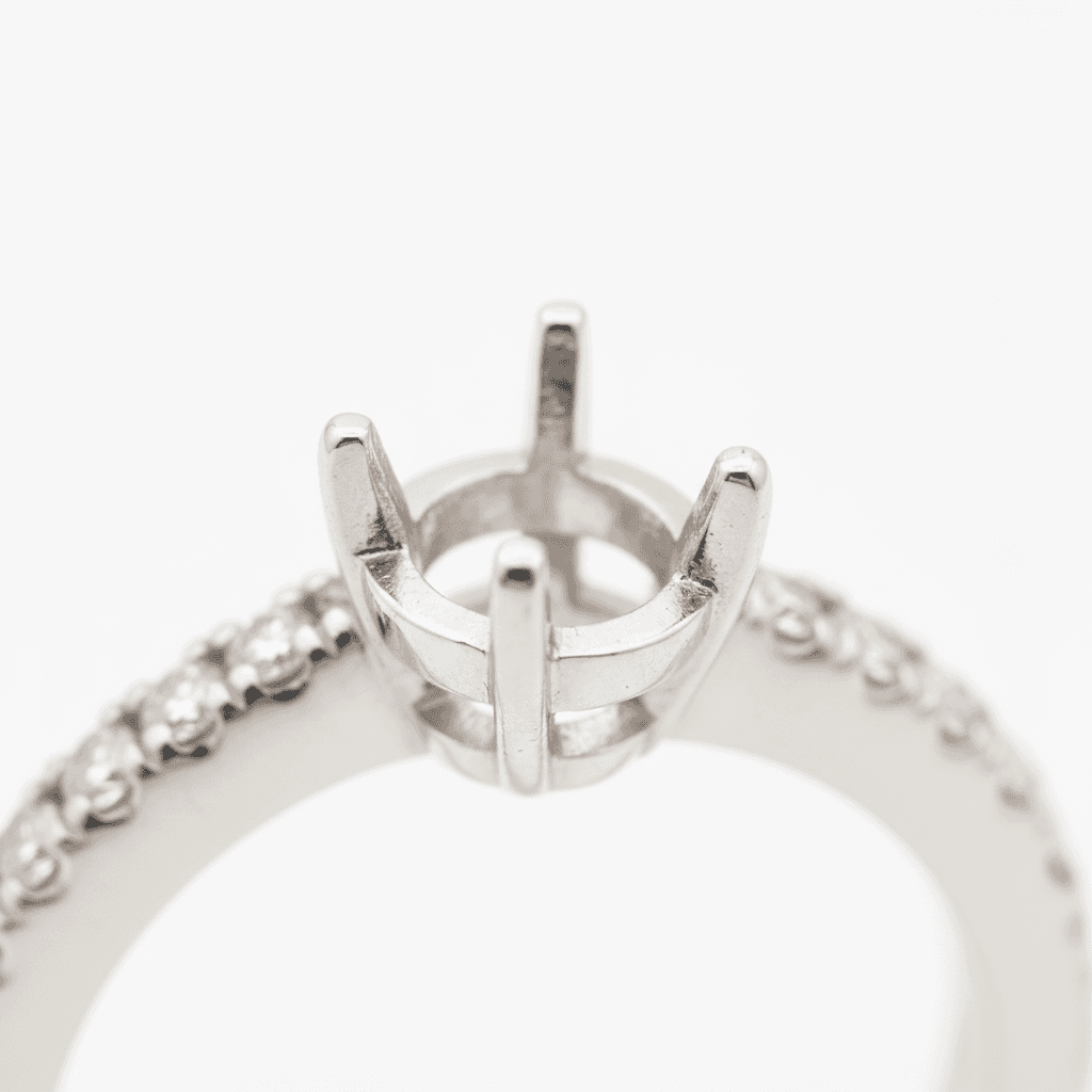 White gold engagement ring mounting with four-prong head and diamond-set band